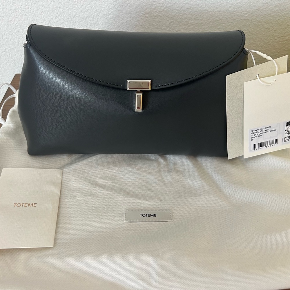 Toteme T-Lock Clutch – Shark Grey with silver hardware.